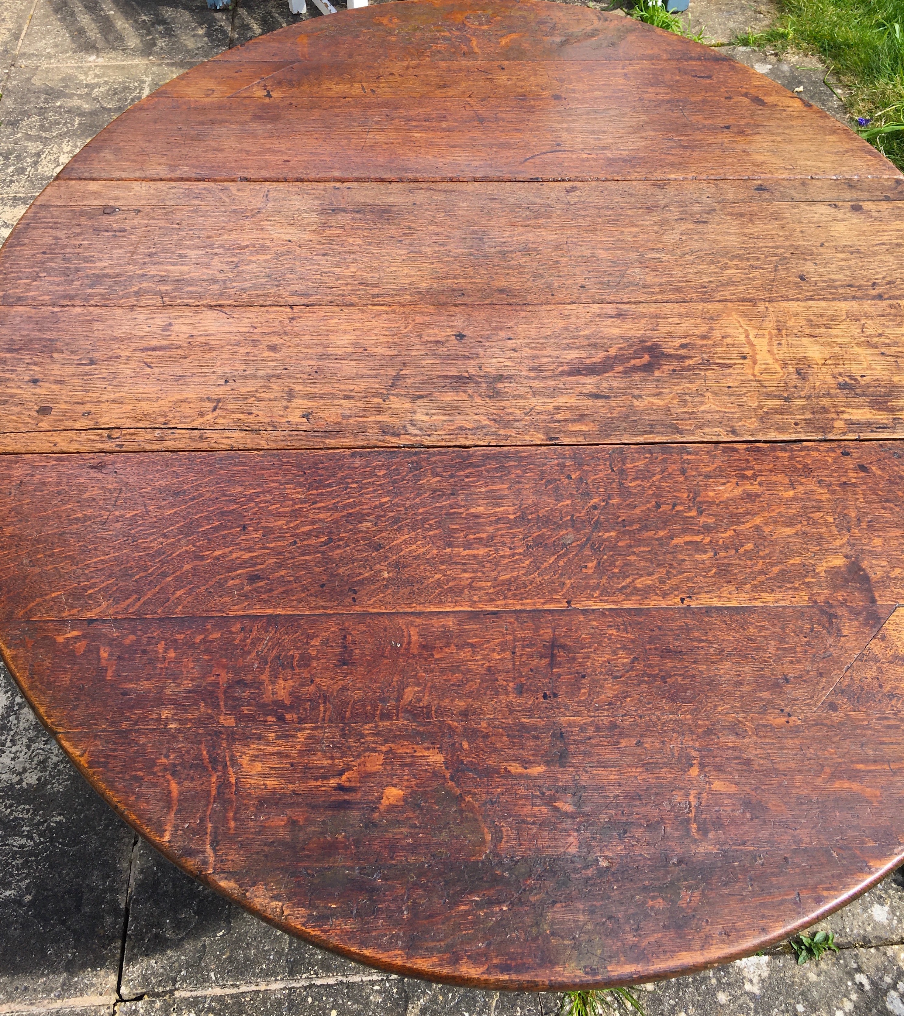 An 18th century oak gateleg dining table, the turned underframe with traces of old paint, length 123cm, depth extended 134cm, height 72cm *Please note the sale commences at 9am.